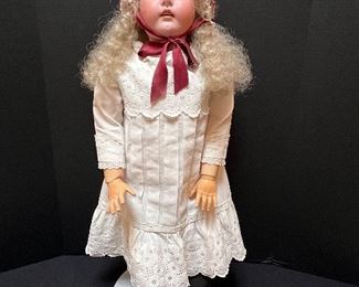 Vintage German Kestener Doll wearing a lovely dress! She measures about 32" h and is marked M 1/2 Germany 16 1/2 and 171. Her head is made of bisque and her body is composition. She has glass eyes and features an open mouth. Her body is jointed. Blue sleep eyes, antique dress and signed body.
Her wig is newer. She has some wear to her body and the two under slips she is wearing have some stains and small tears. Her body is stamped Excelsior Germany