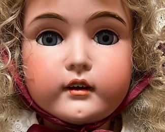 Vintage German Kestener Doll wearing a lovely dress! She measures about 32" h and is marked M 1/2 Germany 16 1/2 and 171. Her head is made of bisque and her body is composition. She has glass eyes and features an open mouth. Her body is jointed. Blue sleep eyes, antique dress and signed body.
Her wig is newer. She has some wear to her body and the two under slips she is wearing have some stains and small tears. Her body is stamped Excelsior Germany