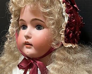 Vintage German Kestener Doll wearing a lovely dress! She measures about 32" h and is marked M 1/2 Germany 16 1/2 and 171. Her head is made of bisque and her body is composition. She has glass eyes and features an open mouth. Her body is jointed. Blue sleep eyes, antique dress and signed body.
Her wig is newer. She has some wear to her body and the two under slips she is wearing have some stains and small tears. Her body is stamped Excelsior Germany