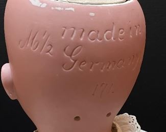 Vintage German Kestener Doll wearing a lovely dress! She measures about 32" h and is marked M 1/2 Germany 16 1/2 and 171. Her head is made of bisque and her body is composition. She has glass eyes and features an open mouth. Her body is jointed. Blue sleep eyes, antique dress and signed body.
Her wig is newer. She has some wear to her body and the two under slips she is wearing have some stains and small tears. Her body is stamped Excelsior Germany