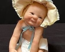 Laura Lee Waubach Seated Baby Doll. Sculpted of a polymer mix. She has beautiful glass blue eyes and auburn mohair hair.
Measures about 7”