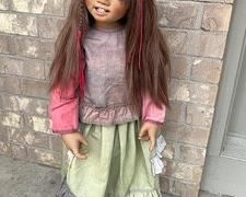 Annette Himstedt's "Bunda" From the 2005 "World Children Collection" Bunda is one of Annette's most sought after dolls in the 2005 collection and is from a limited edition of 377. She represents a young girl from Russia and is a single head usage. Bunda stands approximately 35" tall. Adorable Bunda has amazing brown mouth-blown glass eyes, long brown semi hand-knotted human hair, and the cutest little crooked and endearing smile that will capture your heart.. Bunda is in excellent condition. She has been kept in a climate-controlled, smoke-free environment.