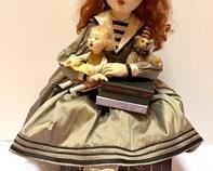 Friedericy Doll - Amazing Artisan Created Doll by Friedericy. This intricate and lovely designed Doll is wax over porcelain. She is holding an adorable doll of her own and an artisan created teddy bear and is sitting on a stack of faux decorative books. The bear is crafted by Theresa's Bears. The doll, sitting down, measures bout 18" h