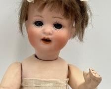 Antique German Heubach Koppel Doll with an adorable face featuring blue eyes and open mouth with teeth. B
Bisque socket head, wigged, painted brows and lashes, glass eyes, open mouth on a composition jointed, bent limb baby body, doll marked 300 Heubach Köppelsdorf.
She has some wear to her body, please view all photos and some stains/wear to her clothing.
Marked Germany 300 16/10
