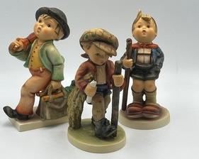 Three Hummel Figurines; Hummel Figurine Merry Wanderer, Hummel Figurine On Secret Path & Hummel Figurine Little Hiker. These figurines may have some crazing. Measuring about 6” each