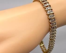 This stunning 18K Gold over Sterling Silver Bracelet with Diamond Accents measures 7 inches long. It does come with the original box.