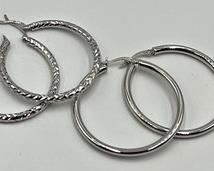 Two Pairs of Sterling Hoop Earrings in new condition measuring about 1.5"