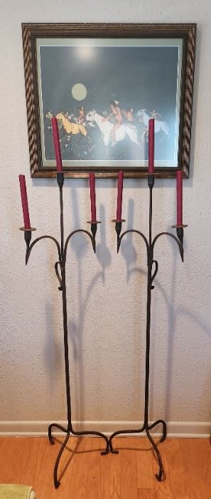 A pair of tall iron candelabra 