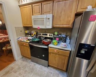 miscellaneous kitchen items including toaster over, coffee maker, waffle maker, pots and pans, can opener