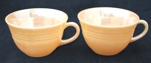 1073 - Pair Fire King peach luster mugs 2 1/2
