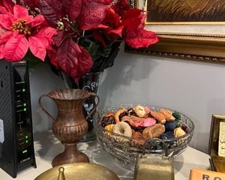 Brass bell, ashtray, lidded box and holiday flowers. 