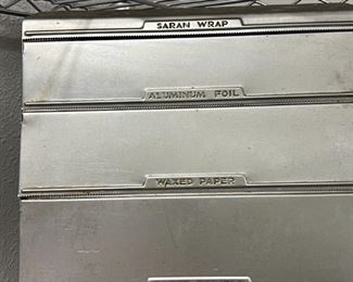 Vintage metal wall mount saran wrap, foil, wax paper and paper towel holder. 