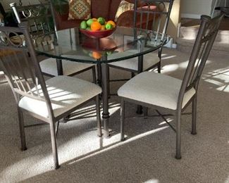 Glass top table with heavy iron base and (4) chairs