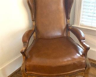 Brown leather modified wing back arm chair