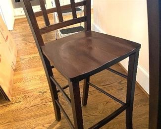 One of four solid wood counter chairs