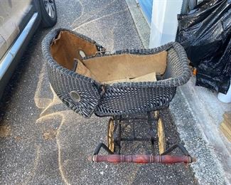 Late 1880’s wicker baby buggy. Wood wheels!