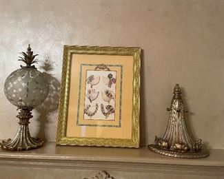 silvered gold accessories shown with glass orb and sconce, and framed vintage hat print in brass frame