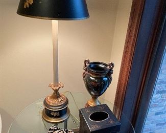 Another view of the metal side table with glass top, buffet lamp with black shade and "bee" decor, black porcelain urn, and black hand-painted bathroom accessories
