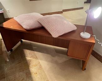 MCM-styled desk cabinet on the right side, desk lamp and pillow shams (terra cotta and white)
