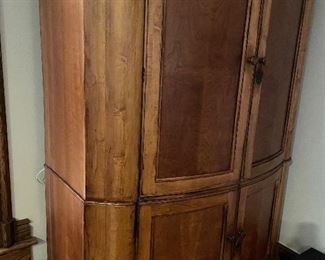 This large armoire that would be marvelous as a bar by installing a mirrored back and wine glass rack.  The lower storage area has a deep wood shelf and the upper section also has internal shelf