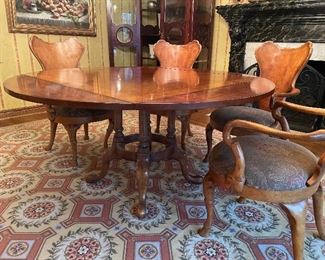 60" round dining table with drop leaves (becoming square), curved wood dining armchairs with upholstered seats, Stark needlepoint rug