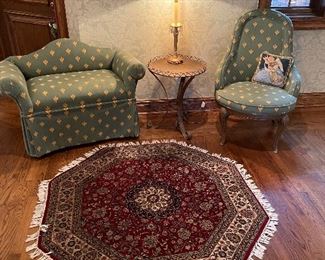 Upholstered settee and side chair in "bee" pattern, metal side table and brass and crystal lamp, 41" octagonal 100% wool area rug with hand-tied fringe