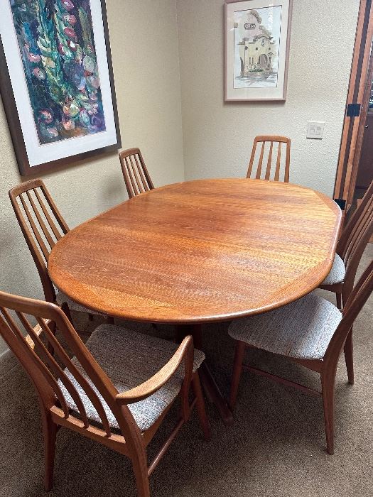 1970’s teak table with large leaf. “Eva” chairs, two have arms. 