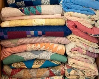 Assortment of hand-made vintage and modern quilts