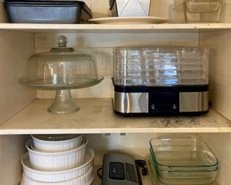 Assorted glass and metal baking pans, loaf pans, glass cake plate with lid, dehydrator, Corningware, vacuum sealer