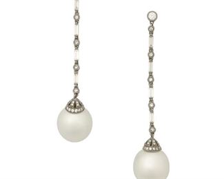 10
A Pair Of South Sea Cultured Pearl And Diamond Ear Pendants
18k black gold; Stamped: K18
Set with two South Sea cultured pearls each gauged at 12mm further accented by eight baguette-cut diamonds and sixty-six round full-cut diamonds totaling 0.88ct. in weight and graded H-I color and SI clarity
0.50" W x 2.25" H
9.7 grams
2 pieces
Estimate: $2,000 - $3,000