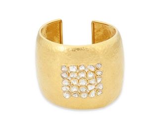 12
An Indian Diamond Cuff Bracelet
22k gold
Set with twenty-five tablet-cut diamonds largest gauged at approximately 5mm in diameter each graded J-K color and I1-I2 clarity on a hammered 22k yellow gold cuff bangle bracelet
2.0" W x 7.0" Cir
59.7 grams
Estimate: $1,500 - $2,000