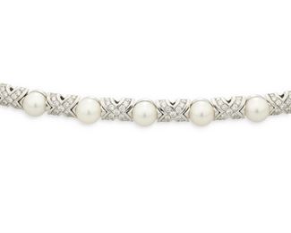 29
A Bulgari Cultured Pearl And Diamond Necklace
18k white gold; Stamped: 750 / Bvlgari
Set with twenty-seven cultured pearls each gauged at 7mm alternating with a diamond topped "X" motif set with three hundred fifty-one round full-cut diamonds totaling approximately 7.25cts. and graded F-G color and VS clarity
16.5" L x 0.25" W
71.2 grams
Estimate: $4,000 - $6,000
