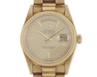 40
A Rolex "President" Gold Wristwatch
1985/86
A circular champagne tapestry dial with gilt baton hour markers, day-date apertures, baton luminous hands, signed Rolex / Oyster / Perpetual / Superlative / Chronometer / Officially / Certified with a 27 jewel quickset movement, Cal: 3055, (not examined) within an 18k yellow gold case & bracelet, fluted bezel, screw-down crown, presidential bracelet, case and bracelet hallmarked, Serial: 8875320
44mm x 36mm, 8.0" Dia
140 grams gross <br /> Movement: 27 jewel quickset movement, Cal: 3055, (not examined) <br /> Case/Bracelet: 18k yellow gold case & bracelet, fluted bezel, screw-down crown, presidential bracelet, case and bracelet hallmarked, Serial: 8875320
Estimate: $10,000 - $15,000