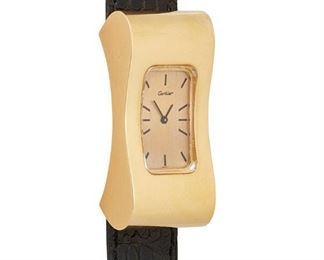45
A Cartier Exaggerated Gold Wristwatch
1970's, 18k yellow gold
A rectangular matte gilt dial, black hour markers, signed Cartier with an 18 jewel stem wind and set movement, Ebel & Co., Cal: 59 within an 18k yellow gold case, #21483 / 75948, uniquely exaggerated & contoured case and crystal, hidden lugs and winding stem, hallmarked, skin strap with an 18k gold buckle
48mm x 22mm
40 grams
Estimate: $5,000 - $7,000
