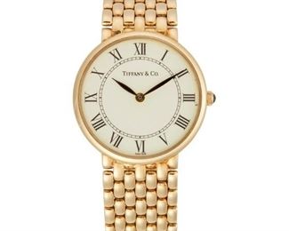 46
A Tiffany & Co. Gold Wristwatch
1980's,14k yellow gold
With a circular white dial with black Roman numeral hour markers, minute track, signed Tiffany & Co. with a 6 jewel quartz movement, ETA 256031, M377
within a circular 14k polished yellow gold case with an integrated woven bracelet, hallmarked
With box
25mm Dia. x 7.25" L
53 grams
Estimate: $2,500 - $3,500
