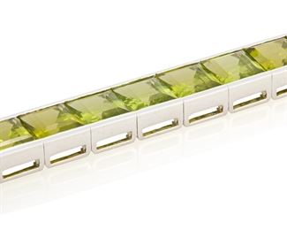 64
A Peridot Line Bracelet
18k white gold
Set with twenty-one rectangular step-cut peridot each gauged at 8.4mm x 8.0mm totaling approximately 65cts. in combined weight
0.375" W x 6.5" L
46.9 grams
Estimate: $4,000 - $6,000