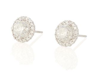 86
A Pair Of Diamond Earrings
18k white gold
Centering a 1.01cts. round full-cut diamond and a 1.06cts. round full-cut diamond each graded H-I color and SI2/I1 clarity further set with thirty-four round full-cut pave set diamonds totaling 0.32ct. in weight and each graded H-I color and SI clarity with post and push backings
0.375" Dia
2.9 grams
2 pieces
Estimate: $2,500 - $3,500