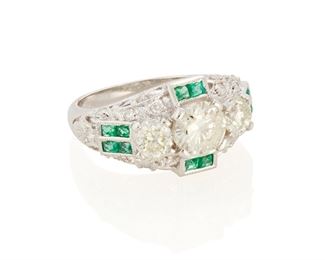 96
An Emerald And Diamond Three Stone Ring
18k white gold; Stamped: 18kt
Centering a 1.06cts. round full-cut diamond graded J-K color and I2 clarity flanked on either side by two round full-cut diamonds totaling 0.83ct. in combined weight and each graded J-K color and I1 clarity further set with twenty round full-cut diamonds totaling approximately 0.25ct. in weight and graded H-I color and SI clarity accented with twelve calibre-cut emeralds
Ring size: 7
6.7 grams
Estimate: $2,500 - $3,500