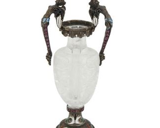 99
A Milanese Silver And Rock Crystal Bottle
19th century, silver
An engraved rock crystal shouldered body with silver mounted handles and base with enamel decoration
4.5" H
#7504
Estimate: $2,500 - $3,500