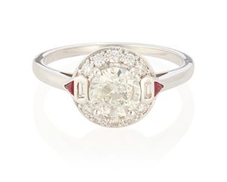 102
A Diamond And Ruby Ring
18k white gold; Stamped: 18k
Centering a 1.04cts. round full-cut diamond graded I-J color and I1 clarity accented by a halo of ten round full-cut diamonds and two baguette-cut diamonds totaling approximately 0.20ct. and further flanked by two small triangular-cut rubies
Ring size: 7
3.3 grams
Estimate: $1,000 - $1,500