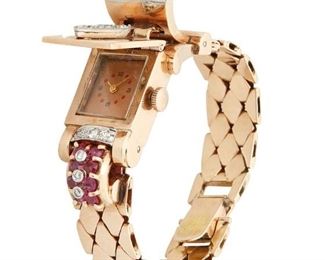 130
A Retro Ruby And Diamond Covered Watch
14k rose gold
Centering three old European-cut diamonds totaling approximately 0.90ct. in combined weight and graded J-K color and SI clarity further set with eleven round full and single-cut diamonds totaling approximately 0.25ct. in weight and graded H-I color and VS clarity accented with fourteen round mixed-cut rubies each gauged at approximately 3.2mm in diameter, hinged cover with spring activated lever revealing rectangular copper tone dial attached to a 17 jewel movement, signed Fils de R. Picard & Co.
5.625" Cir x 0.625" W
54.9 grams
Estimate: $1,200 - $1,800