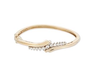 140
A Diamond Hinged Bangle Bracelet
14k yellow and white gold: Stamped: 14k / Stuller
Set with a curved row of thirteen round full-cut diamonds totaling approximately 0.85ct. in weight and graded I-J color and SI/I clarity finished with a fluted gold motif
0.50" W x 6.5" Cir
20.1 grams
Estimate: $1,000 - $1,500