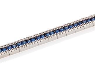 172
A Sapphire And Diamond Bracelet
14k white gold; Stamped: 14k / BH
Centering a row of sixty-two square French-cut sapphires totaling approximately 7.20cts. flanked on either side by two rows of one hundred eighty-six round single-cut diamonds totaling approximately 0.90ct. and graded H-J color and SI/I clarity
0.25" W x 6.75" L
18.2 grams
Estimate: $500 - $700