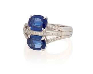 180
A Sapphire And Diamond Ring
18k white gold; Stamped: 18k / 750 / 08
Comprising of two oval mixed-cut sapphires each gauged at 8.8mm x 6.6mm x 3.7mm (and 3.9mm) each weighing approximately 1.70cts. and 1.80cts. further accented with three rows of forty-four round full-cut diamonds totaling approximately 0.40ct. and graded G-H color and SI clarity (ring size: 7)
0.625" H
7.9 grams
Estimate: $600 - $800