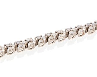 188
A Diamond Bracelet
14k white gold; Stamped: 14k / 31W
Set with one hundred twenty-six round full-cut diamonds totaling approximately 3.75cts. in weight and graded H-J color and I1 clarity
0.125" W x 7.0" L
10.3 grams
Estimate: $1,000 - $1,500