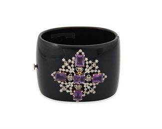 203
An Amethyst, Diamond And Black Acrylic Hinged Bangle Bracelet
14k yellow gold and silver
Featuring five rectangular step-cut amethyst gauged at 8.8mm x 7.1mm surrounded by sixty-four round full-cut and rose-cut diamonds totaling approximately 0.70ct. and graded I-J color and SI clarity and further set with four rose-cut diamonds each gauged at 3.3mm in diameter and graded brown in color and SI/I clarity set onto a wide black acrylic hinged bangle bracelet
1.875" W x 7.0" Cir
58.4 grams
Estimate: $400 - $600