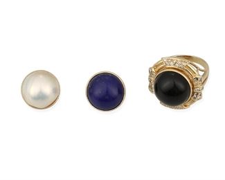 204
An Interchangeable Gemstone Ring
14k yellow gold; Stamped: 14k / 585
The ring features three interchangeable bezel set gemstones including a round cabochon lapis lazuli, onyx and a cultured button pearl each gauged at approximately 14.3mm-14.8mm in diameter and further accented by a halo of thirty-eight round full-cut diamonds totaling approximately 0.55ct. in weight and each graded H-I color and SI/I clarity (ring size: 6.75)
0.875" Dia
18.9 grams
4 pieces
Estimate: $500 - $700