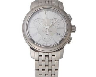 217
A Tiffany Atlas Chronograph Wristwatch
With a circular stepped Guilloche dial, three sub-dials, date aperture, black Roman numeral hour markers, outer track, center sweep-seconds, signed Tiffany & Co with a jeweled quartz movement (not examined) time/date and chronograph complications for start, stop, reset, 30 minute counter, 60 second counter, seconds, & 1/10th second counter within a stainless steel case with link bracelet, signed Tiffany and Co. with two extra links, includes stock box, papers, and warranty card.
47mm x 38mm. 7.5" Dia
124 grams
Estimate: $600 - $800