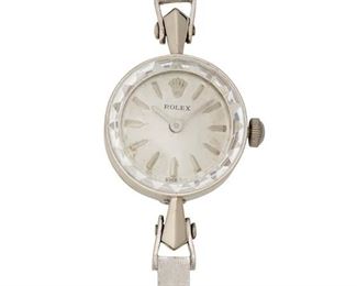 223
A Rolex Gold Wristwatch
1950's-60's, 14k white gold
With a round silvered dial, applied baton hour markers, signed Rolex with a quartz movement, signed Miyota Co. Japan (aftermarket replacement) within a
round 14k white gold smooth polish case, textured bracelet, hallmarked, signed Rolex, #47609
25mm x 15mm, 6.5" L
13 grams
Estimate: $300 - $500