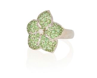 271
A Tsavorite And Diamond Flower Ring
18k white gold; Stamped: 18k
Set with sixty round mixed-cut tsavorite garnets totaling approximately 2.50cts. in combined weight and centering one round full-cut diamond gauged at 0.05ct. (ring size: 7)
0.75" Dia
8.7 grams
Estimate: $600 - $800